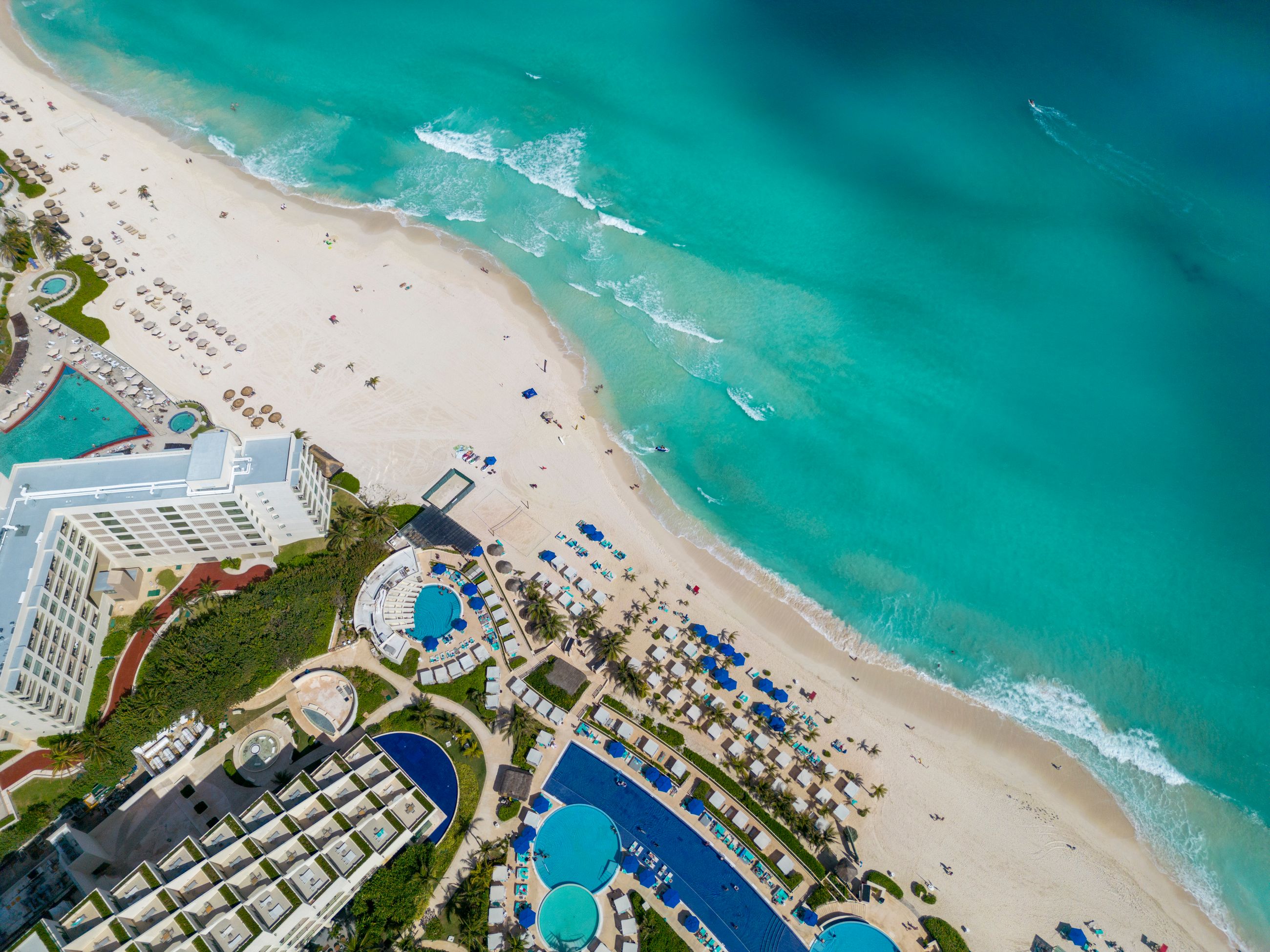 Aerial view of a beachfront hotel, one option for where to stay in the Yucatan Peninsula