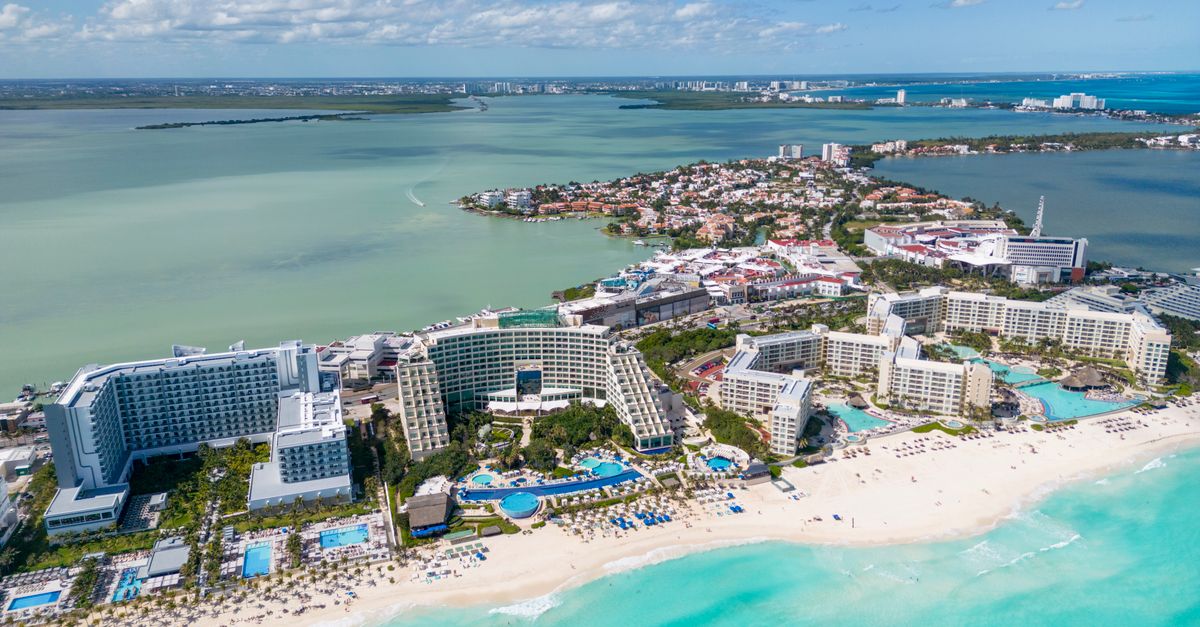 Aerial view of turquoise water and beachfront resorts along the Cancun coastline