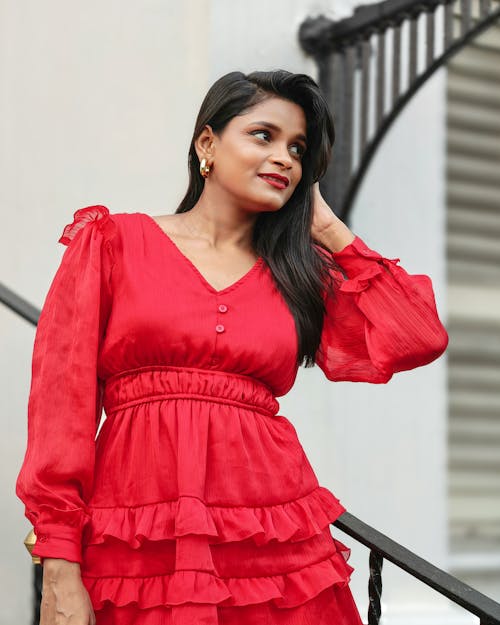 Photo of a Brunette Wearing a Red Dress with Ruffles