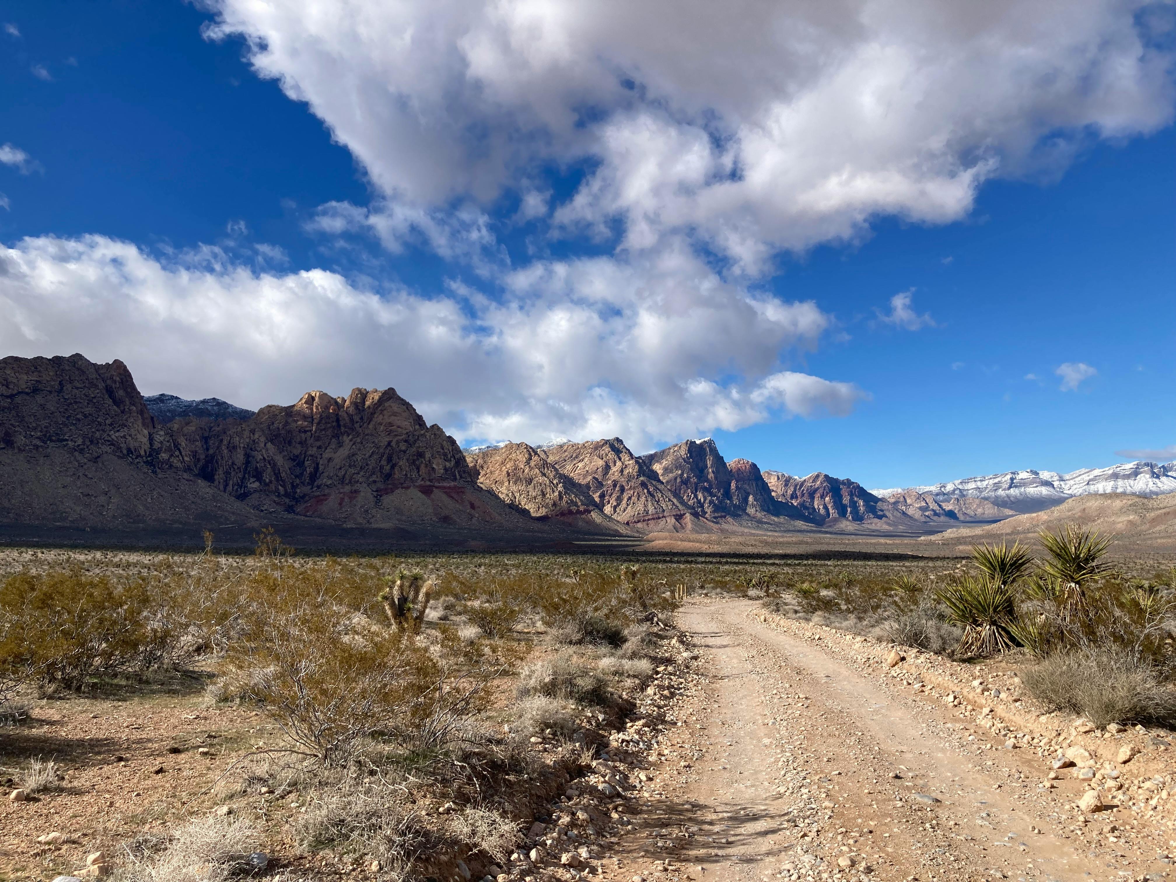 Explore the rugged beauty of desert mountains under a vibrant blue sky.