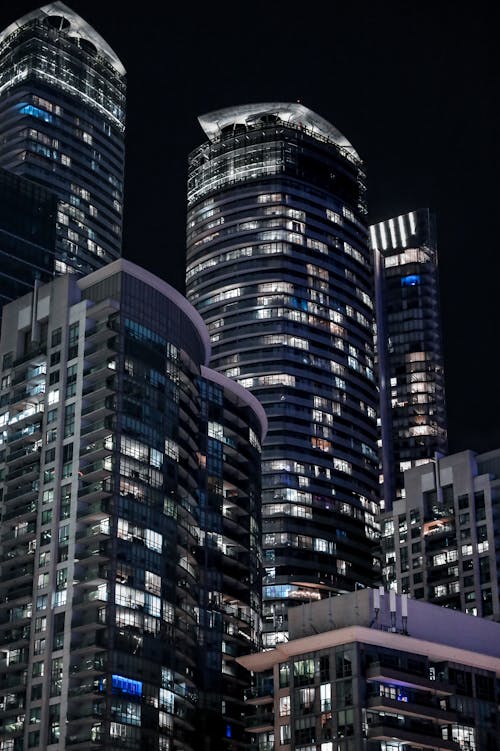 A night time view of tall buildings in a city