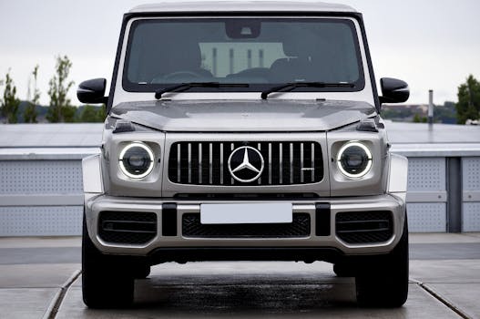 A sleek, gray luxury SUV prominently displayed on an outdoor driveway with a modern backdrop.