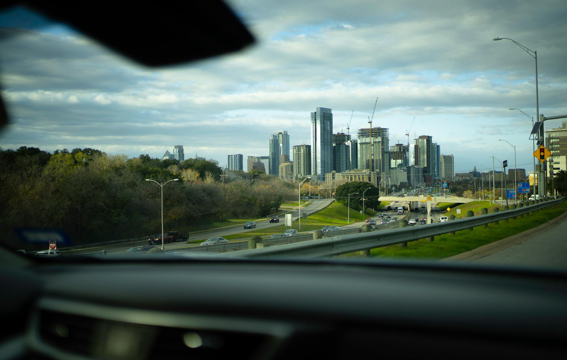 Dynamic view of Austin skyline from a car, capturing skyscrapers and urban life.