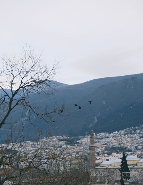 Free Discover a winter cityscape of Bursa, Türkiye highlighted by historic architecture and majestic mountains. Stock Photo