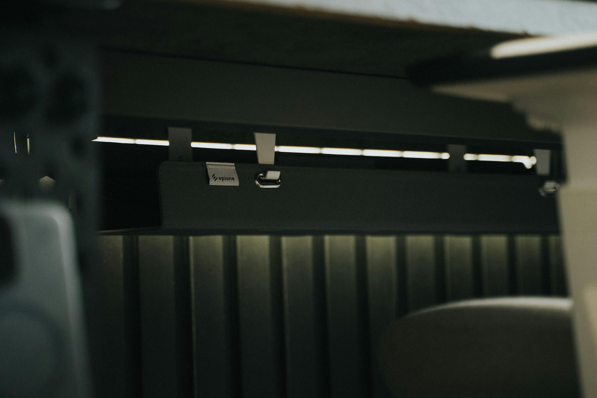 Close-up view of sleek under desk cable management in an office setting, enhancing workspace organization.