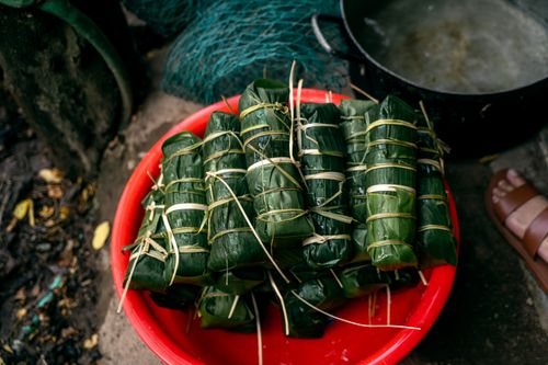 Free High-angle view of traditional Vietnamese Banh Tet wrapped in banana leaves, ready for cooking. Stock Photo