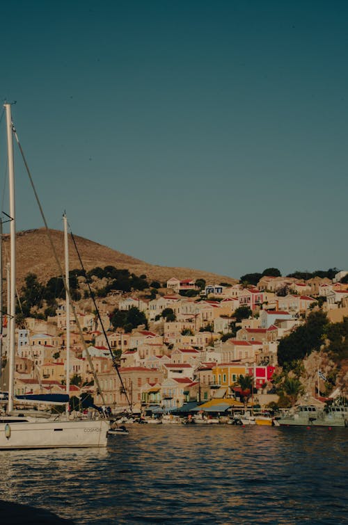 A boat is docked in front of a colorful town