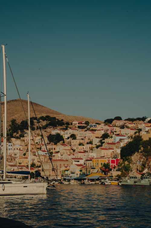 Free A vibrant view of the picturesque old town of Symi Island, Greece, showcasing colorful buildings and boats by the bay. Stock Photo
