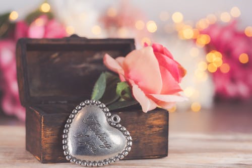 A heart shaped box with a rose and a heart shaped box