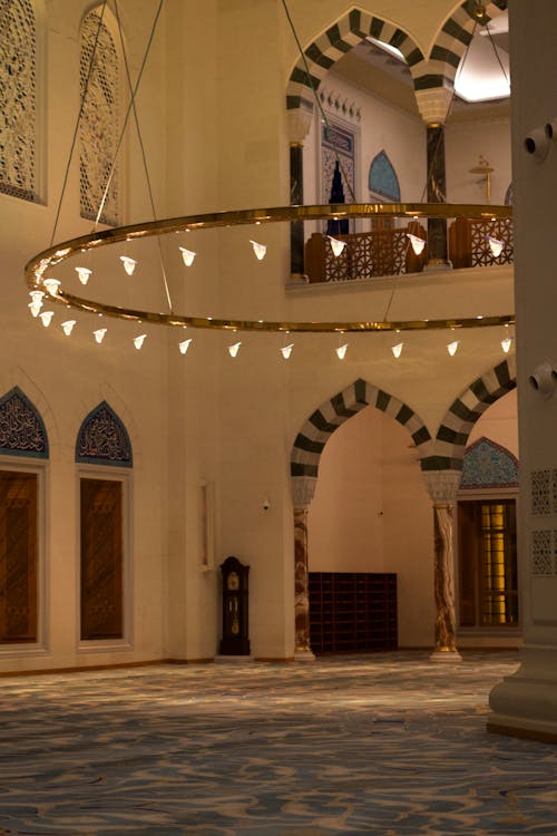 The interior of a mosque with a large circular light
