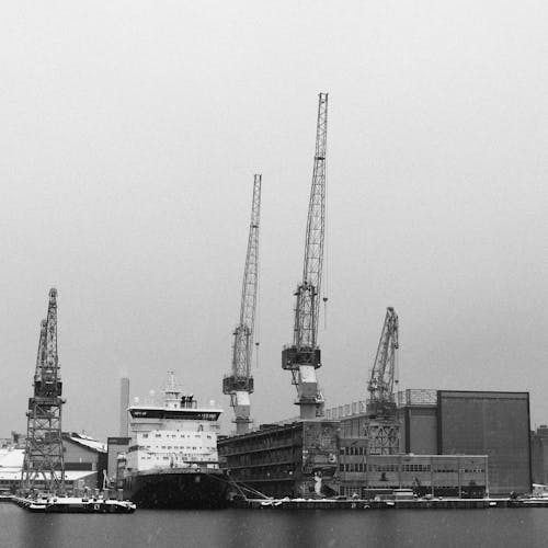 Black and white photo of a ship docked in the water