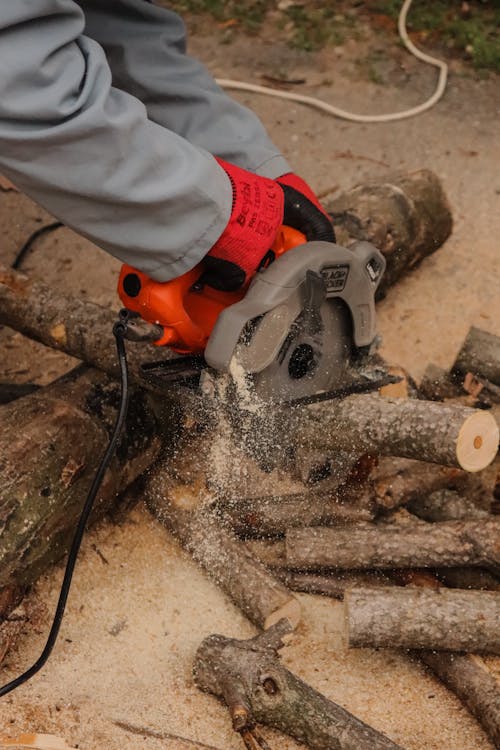 Person Using Sawing Machine to Cut Woods