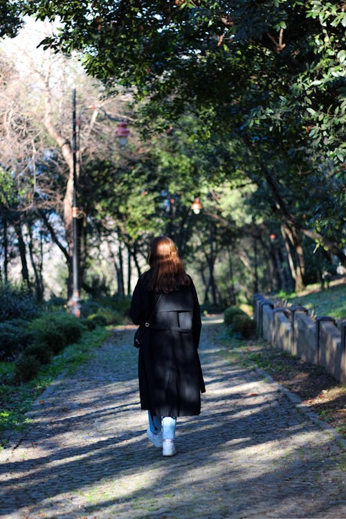 A woman walking down a path in the woods