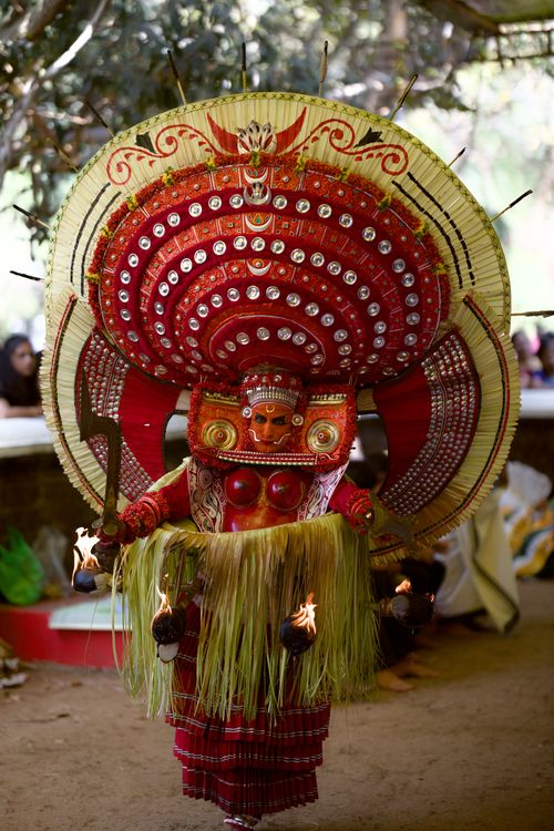 Free Stunning Theyyam performer in vibrant costume with elaborate headgear in Kerala, India. Stock Photo
