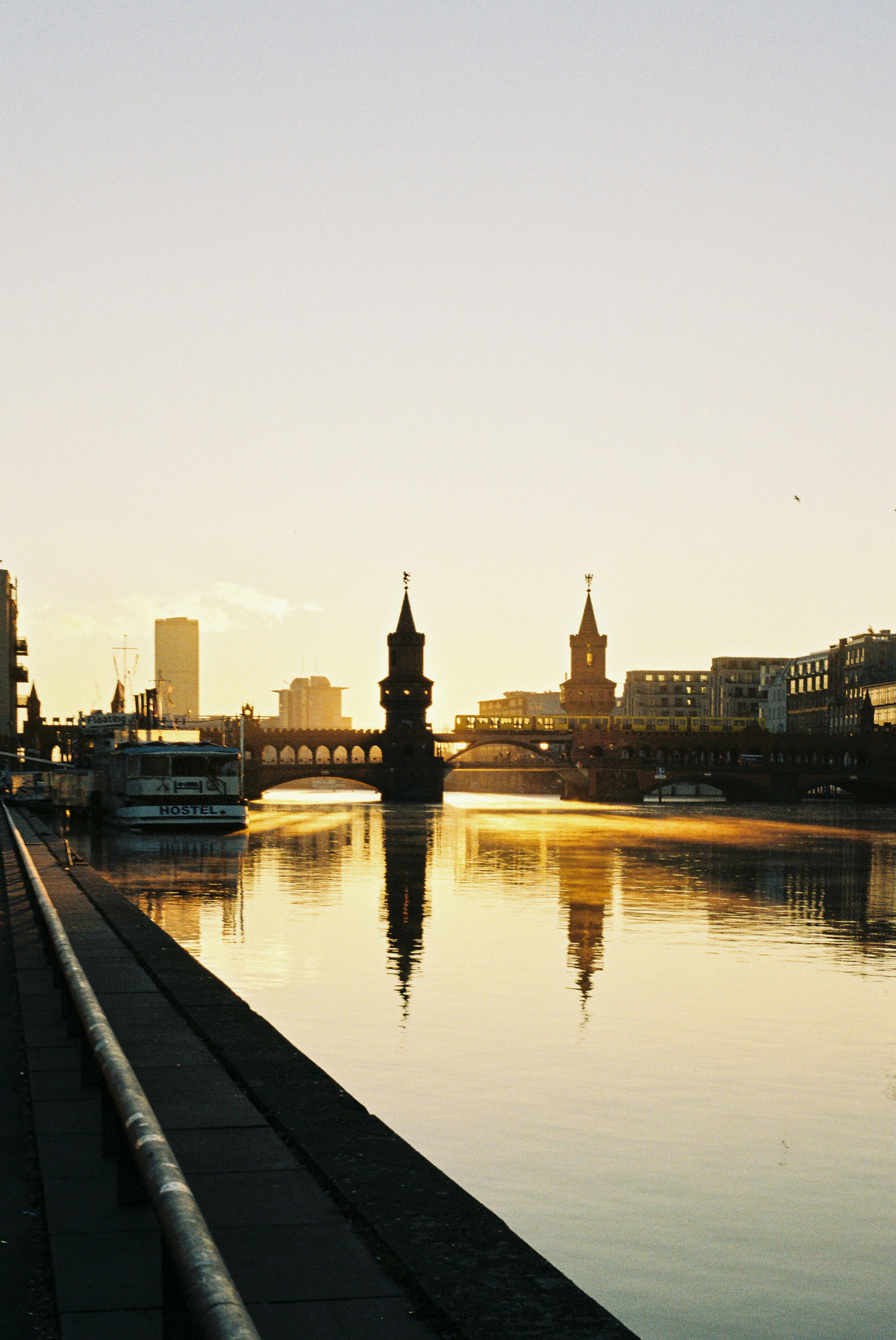 Beautiful sunrise over Oberbaum Bridge in Berlin reflecting on the river Spree.