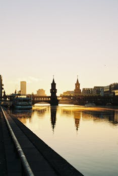 Beautiful sunrise over Oberbaum Bridge in Berlin reflecting on the river Spree.