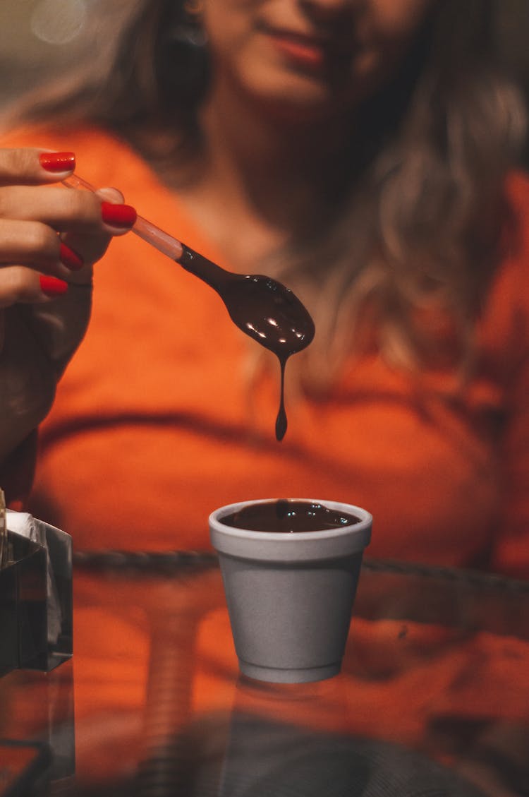 Photo Of Woman Holding Spoon Of Melted Chocolate