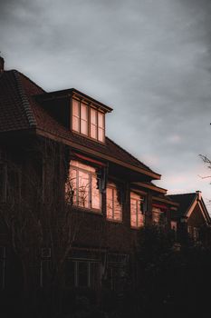 Charming townhouse facades at dusk in Leeuwarden, Netherlands showcasing warm reflections and classic architecture.