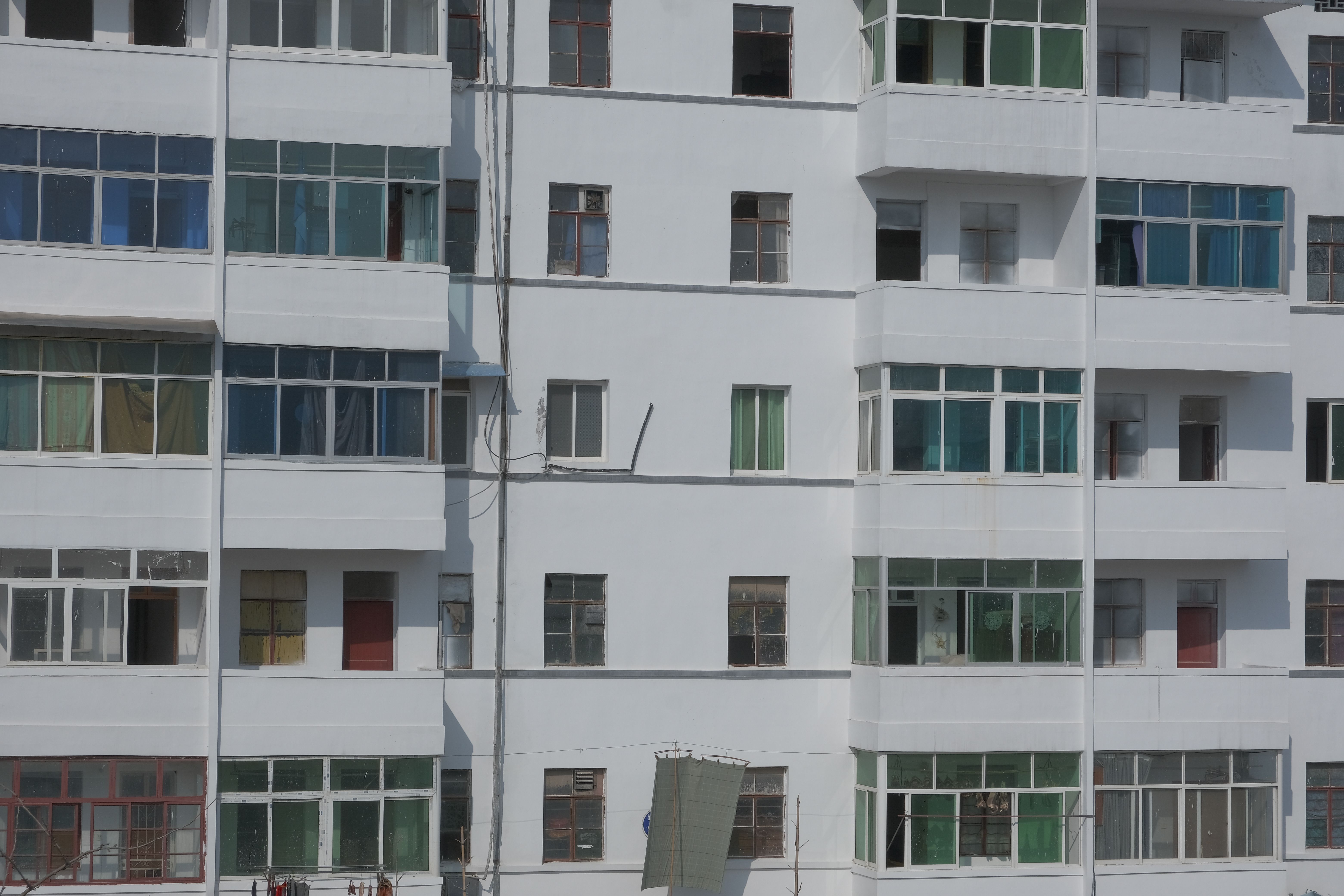 Close-up view of a modern residential building with balconies and windows.