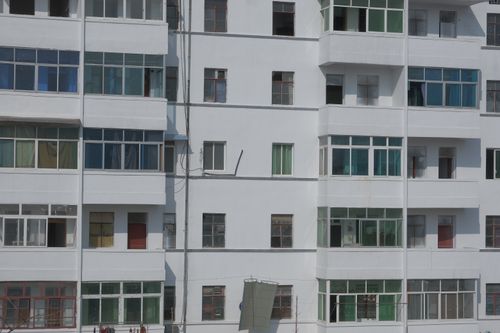 Free Close-up view of a modern residential building with balconies and windows. Stock Photo