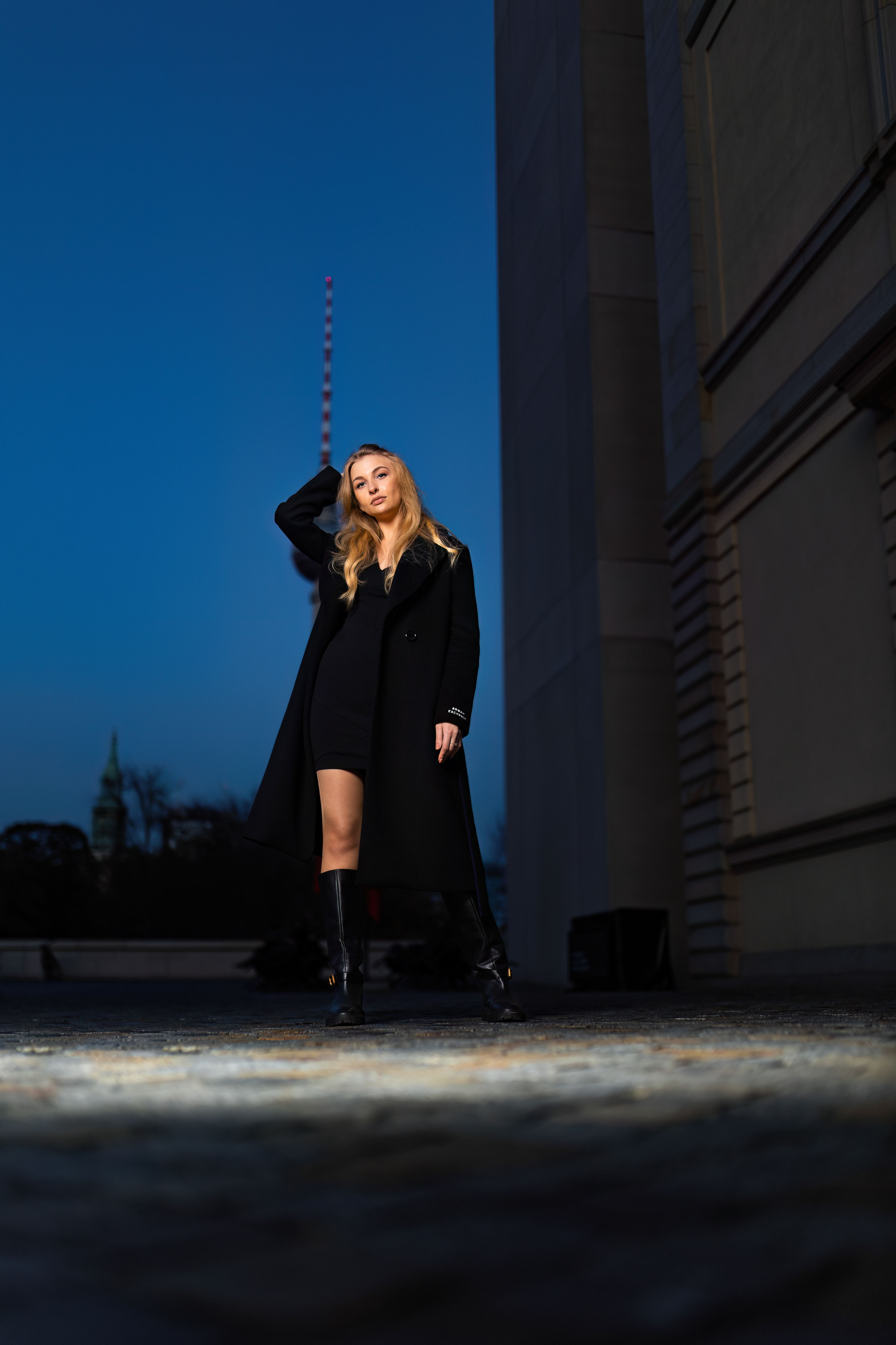 A woman in black coat standing on a street · Free Stock Photo