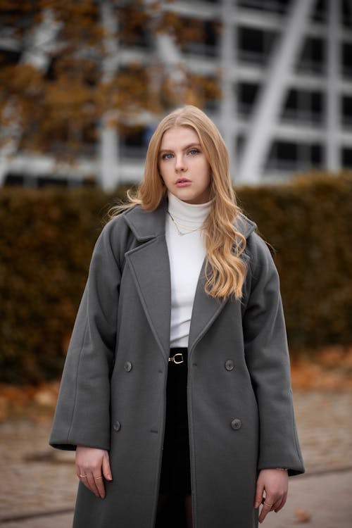 A woman in a grey coat and black turtleneck