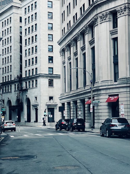 Cars Parked on Side of Street in City Downtown