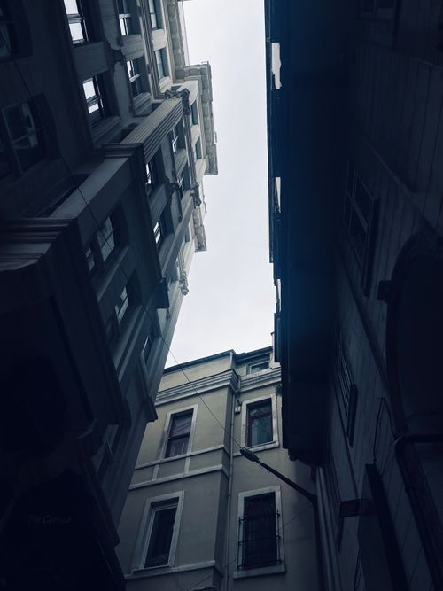 Free A vertical view of tall, closely-packed apartment buildings in an urban setting. Stock Photo