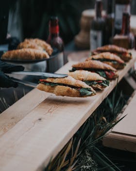 Tasty croissant sandwiches served fresh on a wooden table at an outdoor market in Antalya.