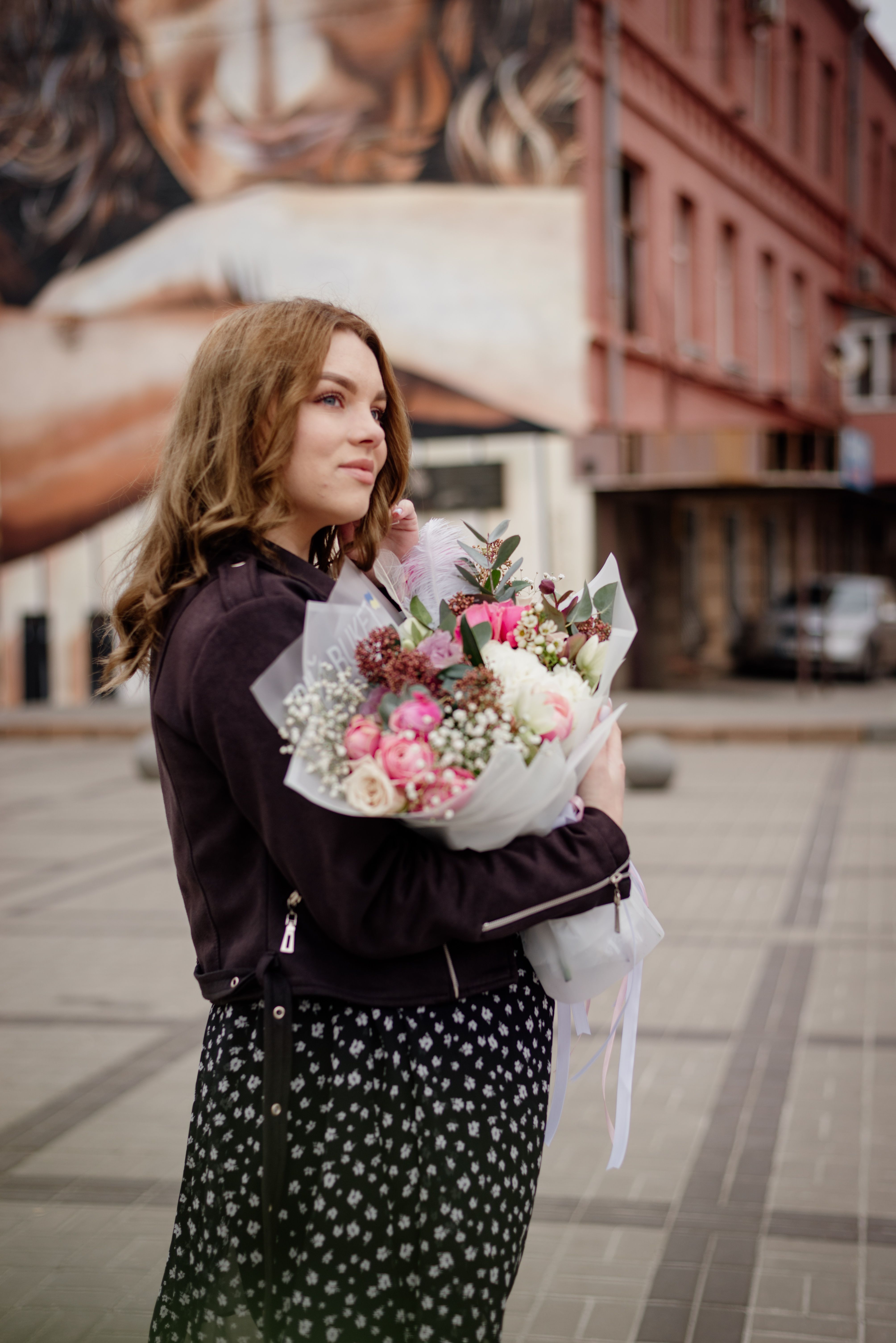 Woman in Jacket Standing with Bouquet of Flowers · Free Stock Photo