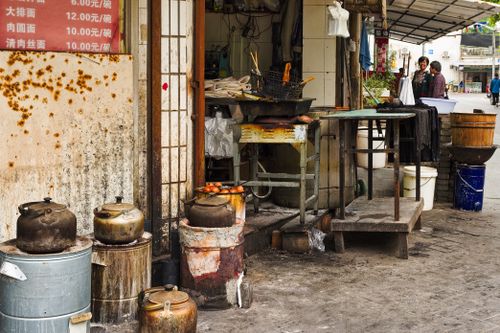 Free An authentic street market setup in Asia showcasing rustic kettles and cooking equipment. Stock Photo