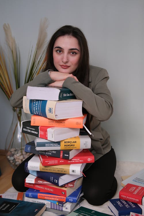 Woman Leaning on Tower of Law Books