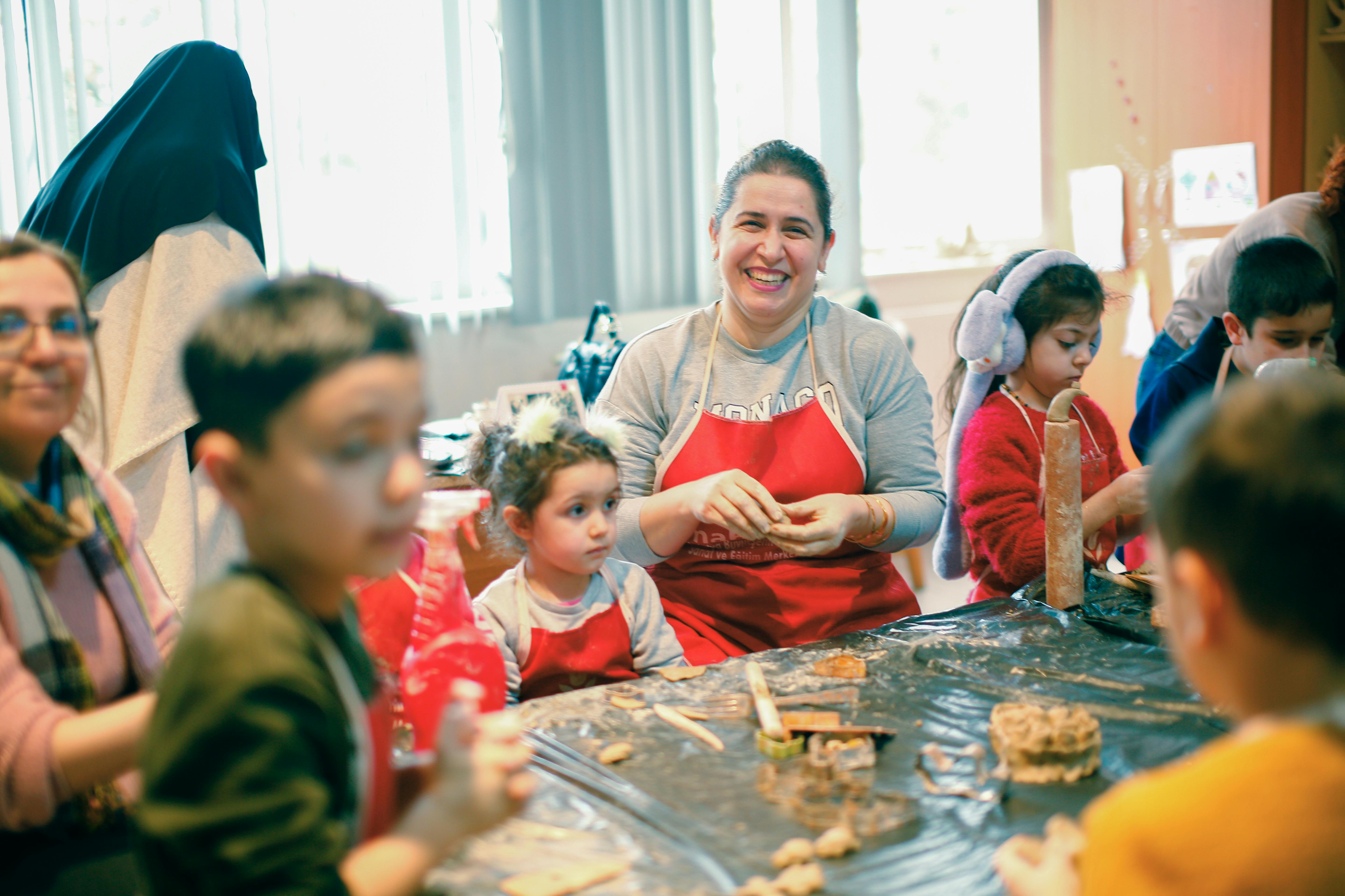 parents and children participating in a hands-on community service activity, smiling