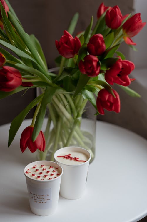 Roses over Cups with Hearts and Love Text on Beverage