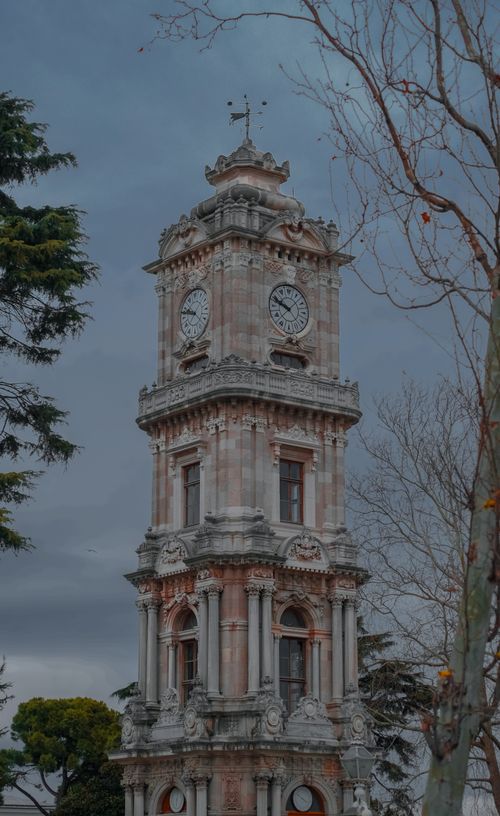 Free Stunning view of the Dolmabahce Clock Tower surrounded by trees in Istanbul, Turkey. Stock Photo
