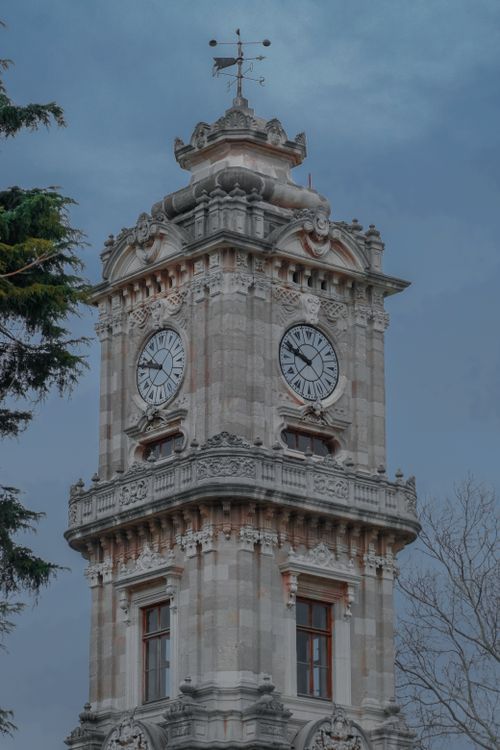 Free Vertical shot of the historic Dolmabahce Clock Tower against a cloudy sky in Istanbul, Turkey. Stock Photo