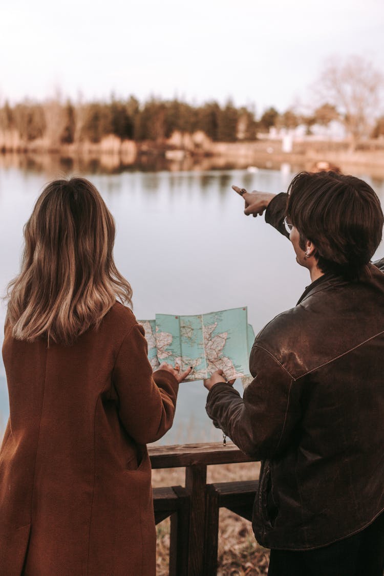 Couple With Map By The Lake