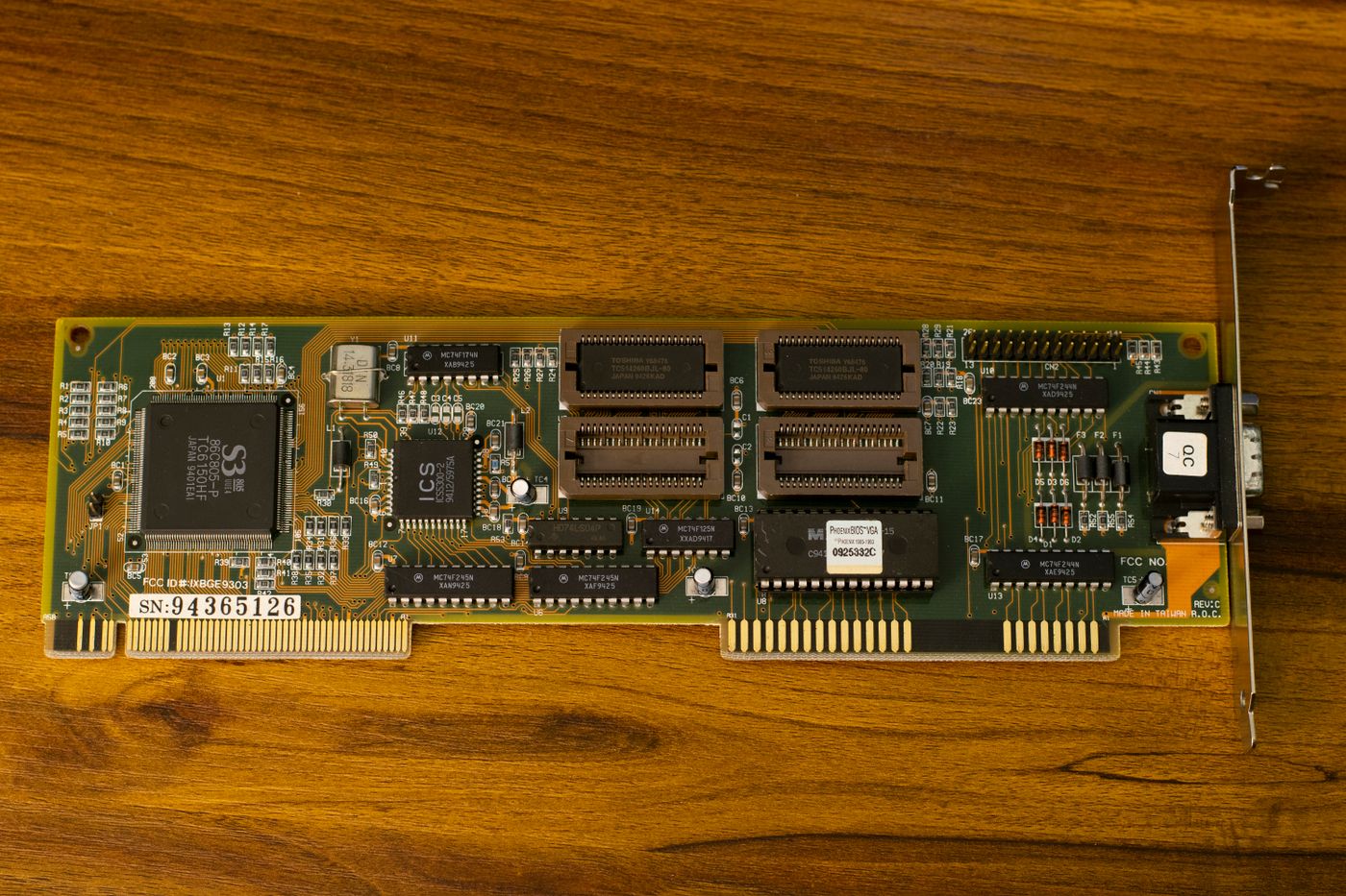Close-up of a vintage computer circuit board on a wooden background.