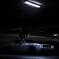Sports car under neon light at night — photo by Brandon Martinez on Pexels