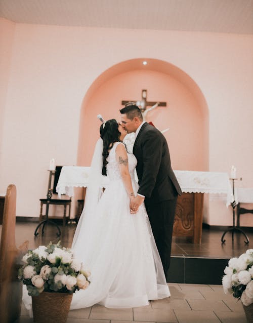 Bride and Groom Kissing at the Altar 