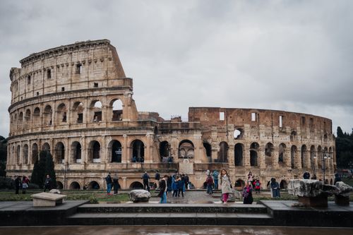 Free Tourists explore the historic Colosseum in Rome, a symbol of ancient architecture. Stock Photo
