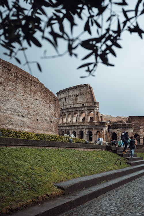 View of the Colosseum and Ancient Temple Wall in Rome, Italy 
