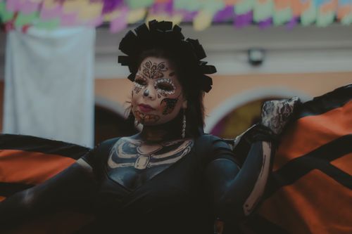 Free Woman in Dia de los Muertos makeup and butterfly costume, celebrating the festival. Stock Photo