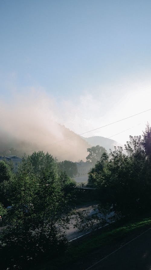 A photo of a mountain with a foggy sky