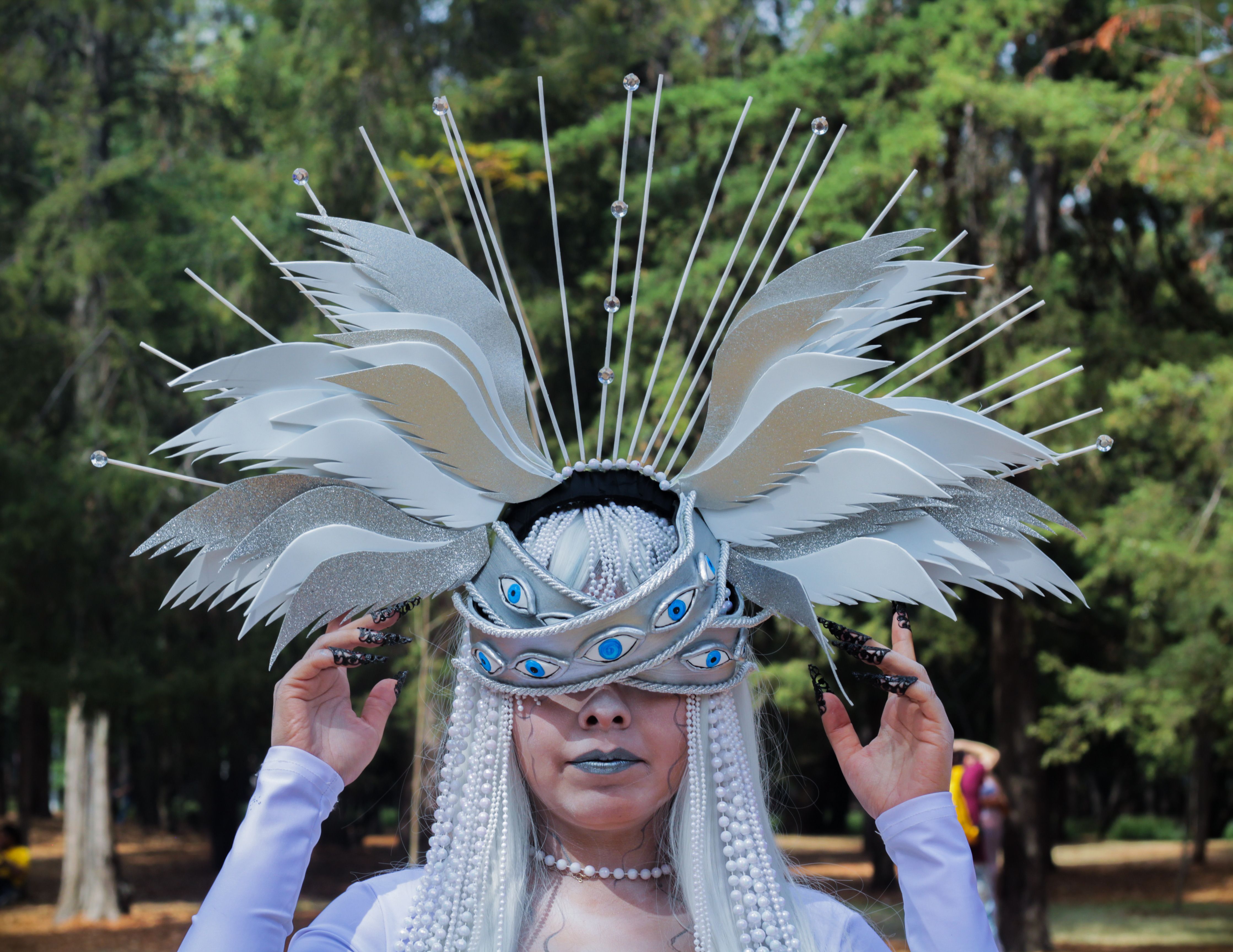 A captivating photo of a person in a detailed fantasy headdress outdoors, ideal for creative themes.