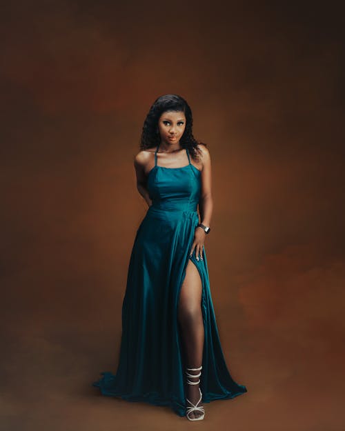 A beautiful woman in a blue dress posing for a photo