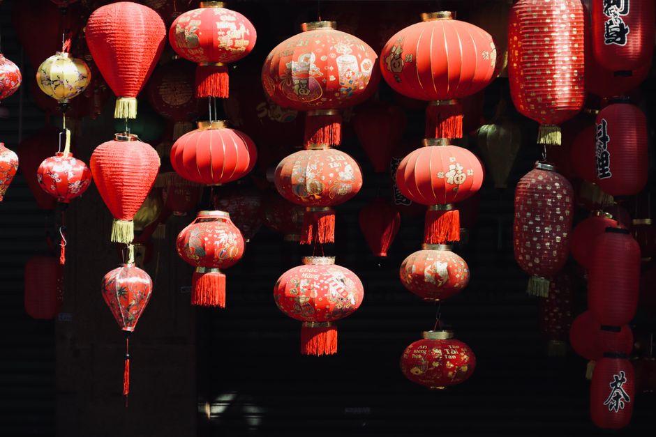 A beautiful array of ornate red Chinese lanterns hanging in the sunlight.