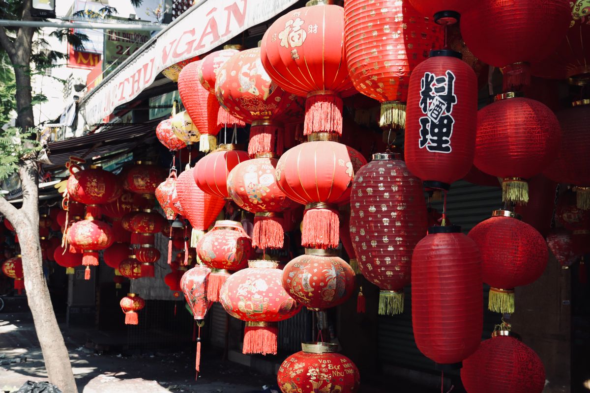 Red traditional Chinese lanterns hanging in a row during a celebration