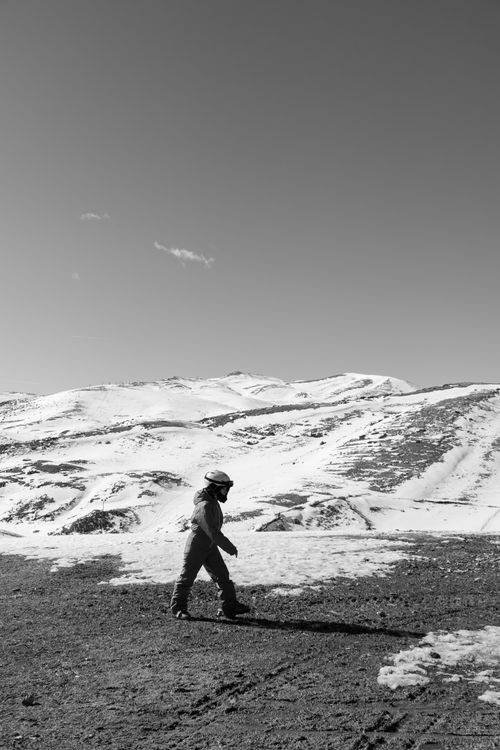 Free Person hiking in snow at Mavrovo, North Macedonia under a clear sky. Stock Photo