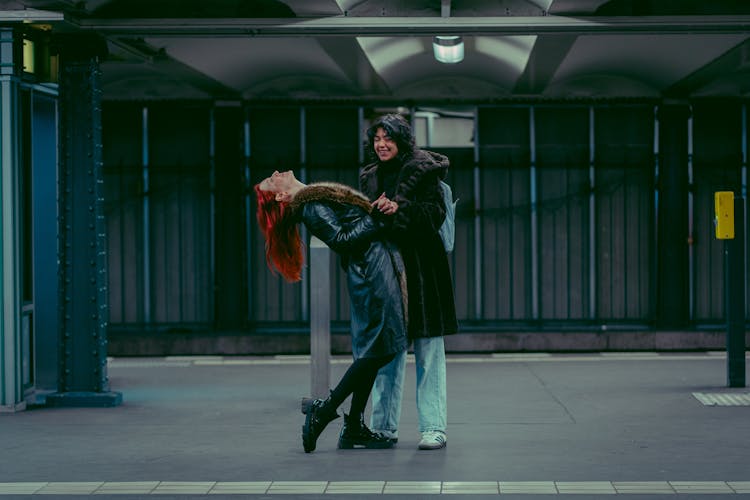 Couple Of Women Dancing In The Subway Station